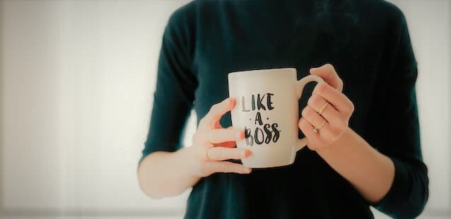 Woman holding a mug with a "like a boss" logo