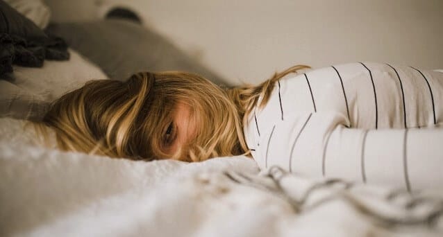 sleepy girl on a bed