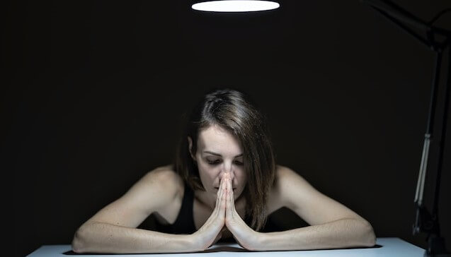 woman in the dark praying