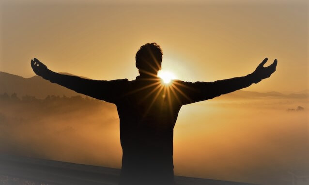 boy silhouette looking at the sun